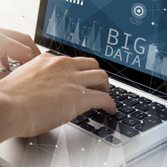 Imported featured image technology and business concept: man using a laptop with big data on the screen. All screen graphics are made up.
